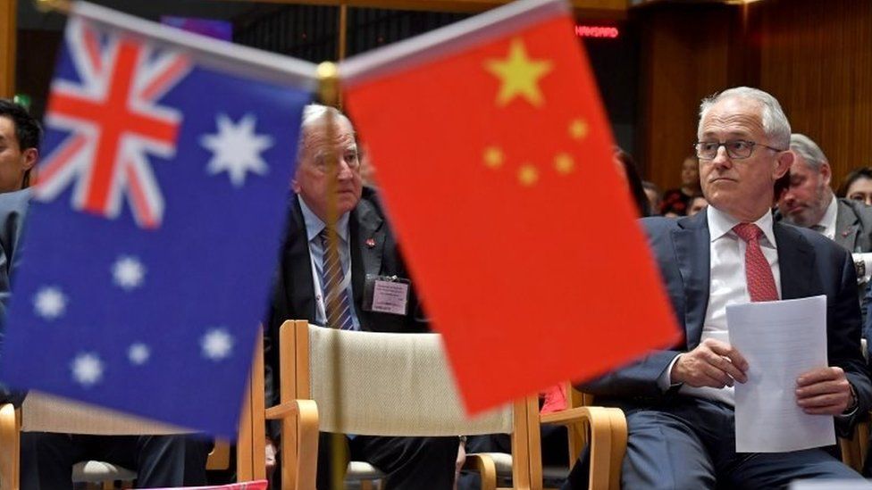 Australian PM Malcolm Turnbull is seated at an Australia China Business Council event last week, next to the flags of Australia and China