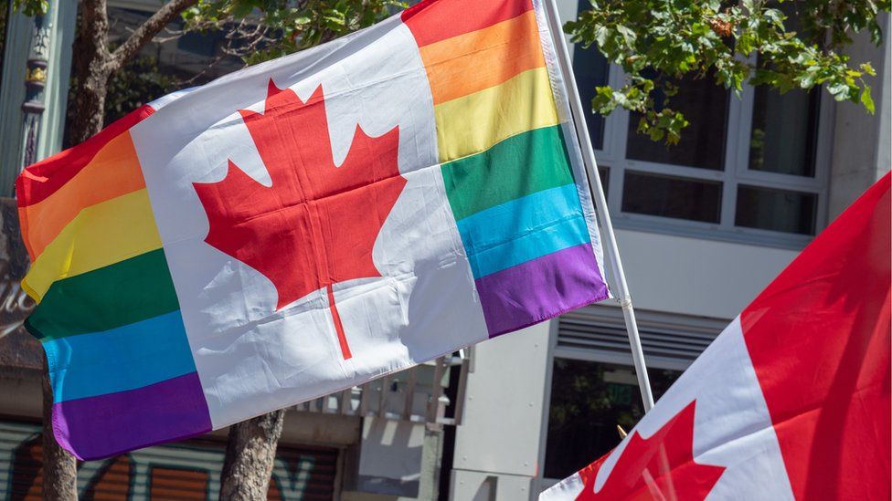 A Canadian flag in the rainbow colours of LGBT pride