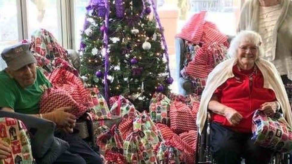 Residents at The Pines nursing home in Glen Falls receive their Christmas gift bags