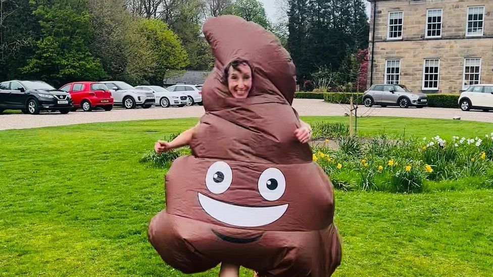 Emma Davies dressed in a poo emoji outfit