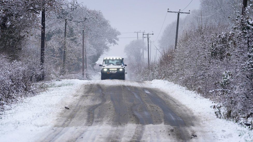 A car   driving on  an icy roadworthy  successful  Kent