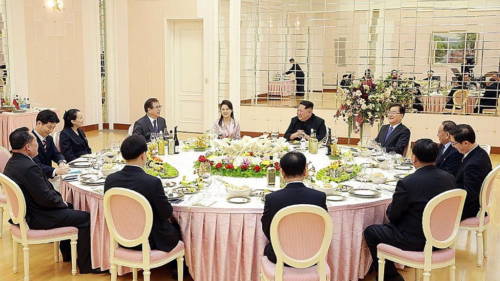 In this handout image from the South Korean Presidential Blue House, Chung Eui-Yong, head of the presidential National Security Office talks with North Korean leader Kim Jong-Un (5th R) during a dinner in Pyongyang, North Korea on March 5, 2018.