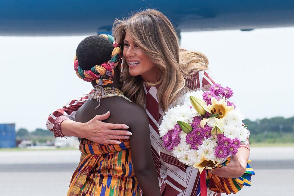 US First Lady Melania Trump receives flowers during an arrival ceremony after landing at Kotoka International Airport in Accra October 2, 2018 as she begins her week long trip to Africa to promote her 'Be Best' campaign.