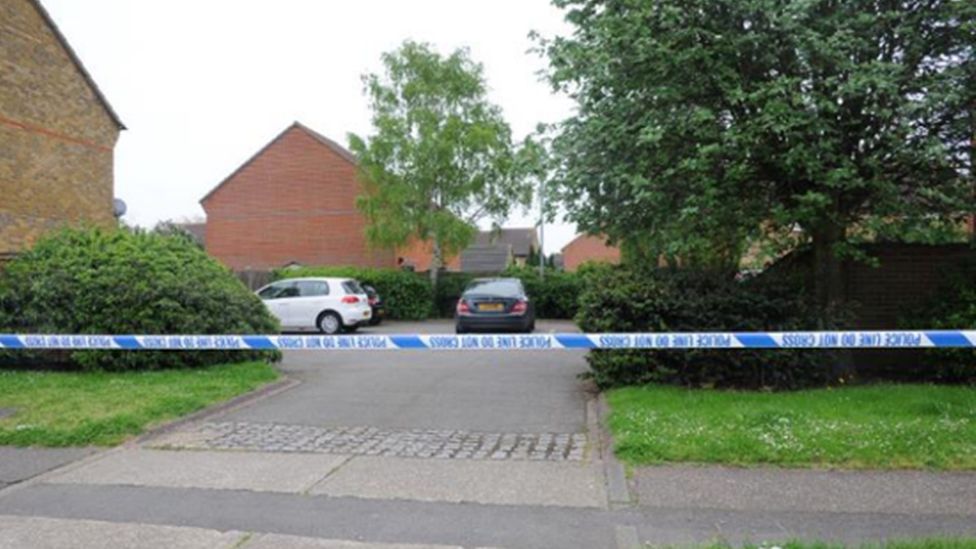 A police cordon with two cars behind it