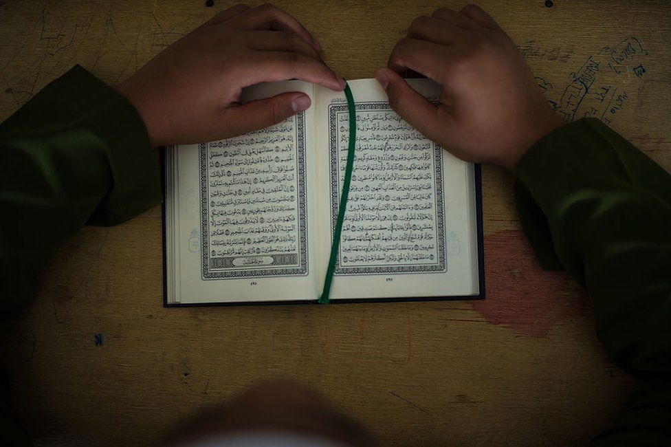 A Malaysian Muslim boy reads the Koran during a Koran lesson at a mosque in Ampang, in the suburbs of Kuala Lumpur on 30 July 2013.