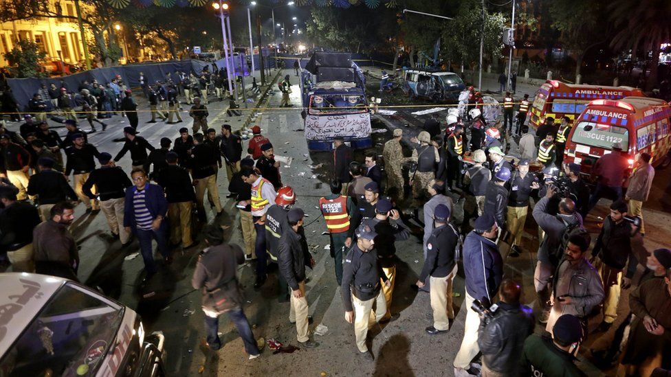 Security officials inspect the scene of a suicide bomb attack that targeted a protest by pharmacists outside the Punjab provincial assembly in Lahore, Pakistan, 13 February 2017