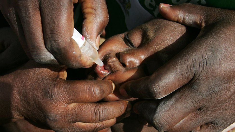 A boy is given a drop of polio vaccine during a nationwide innoculation April 10, 2005 in Rimin Gado, Nigeria.