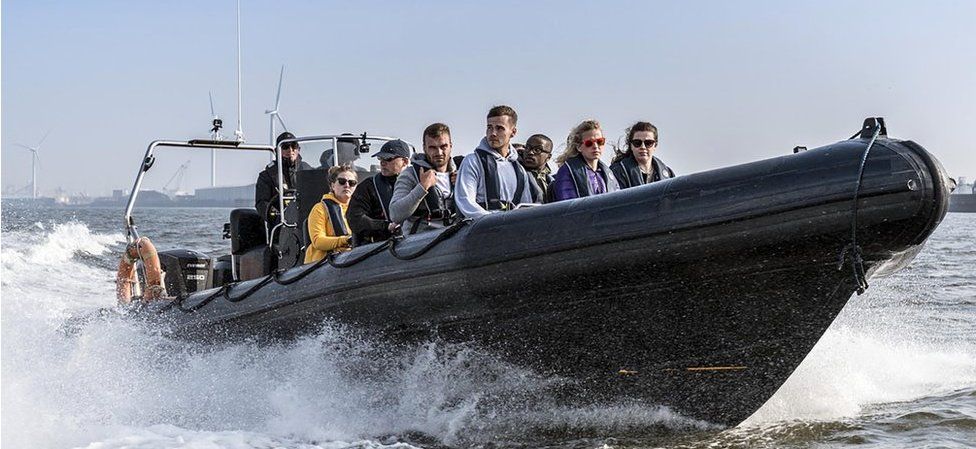 Hunted contestants on a speedboat heading for Liverpool docks