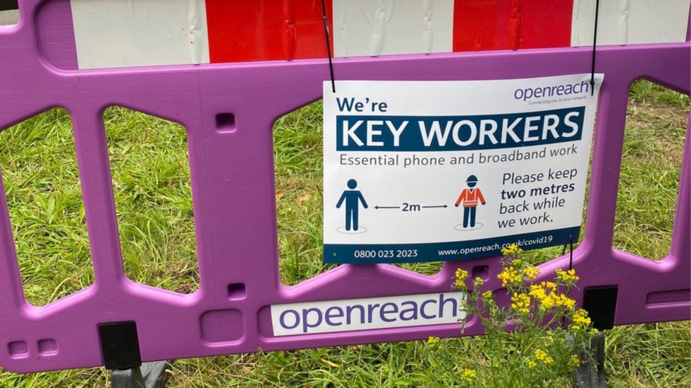 An Openreach key workers sign asks others to maintain distance while its staff do their job