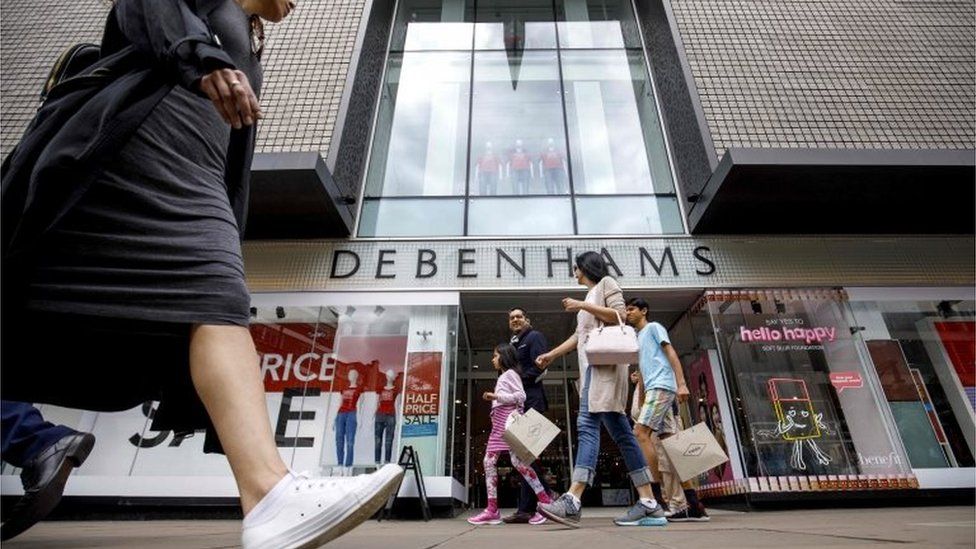 Woman walking past Debenhams