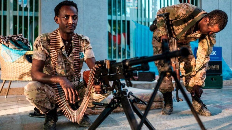 A member of the Amhara Special Forces sits next to a machine gun at an improvised camp in the front of a shop in Humera, Ethiopia, on November 22, 2020