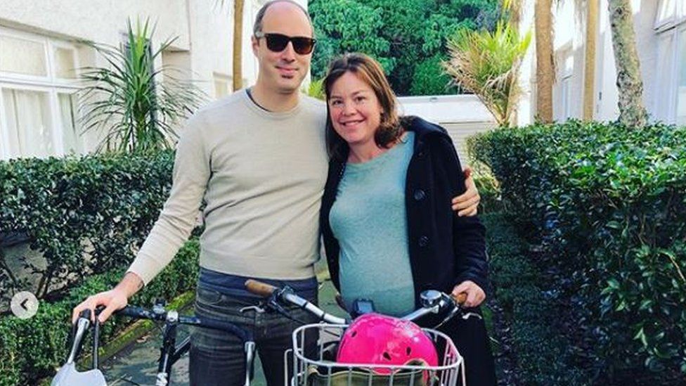Julie Genter poses with her partner Peter and their bikes