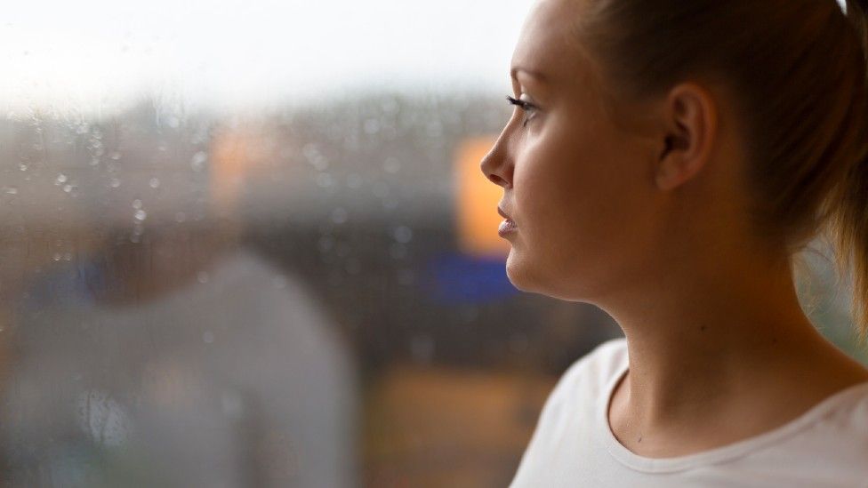 Woman looking out of a window