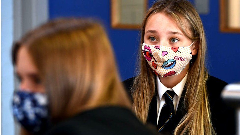 Pupil wearing mask in classroom