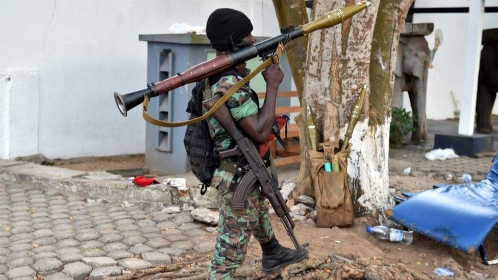 An Ivorian soldier stands guard ouside hotel Etoile du Sud in Grand Bassam, some 40 kms east of Abidjan on March 14 , 2016