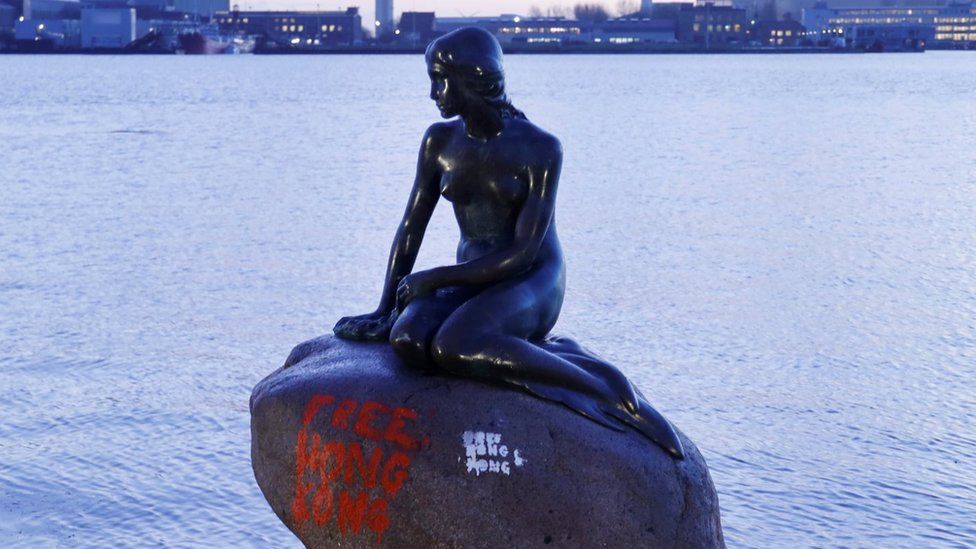 Little Mermaid statue with 'Free Hong Kong' graffiti