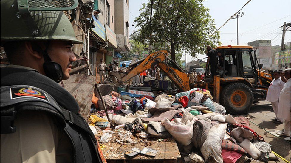 A bulldozer demolishes an illegal structure during a joint anti-encroachment drive conducted by North Delhi Municipal Corporation (MCD) at Jahangirpuri area