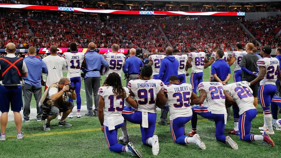 Buffalo Bills players kneel during the national anthem