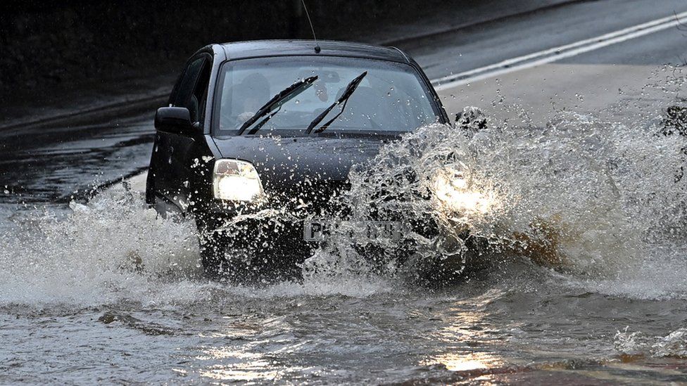 A car drives through flood water in Strines, on 20 January 2021