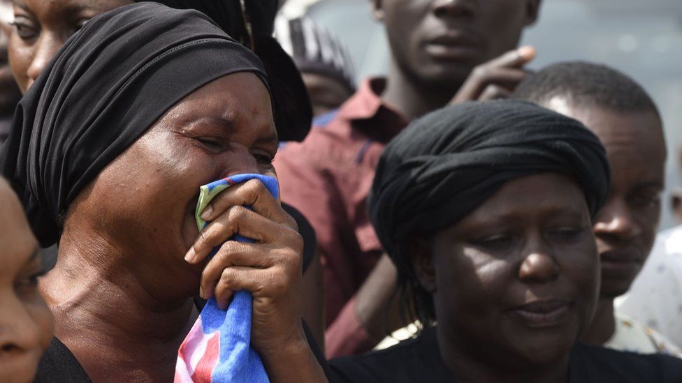 A woman cries as the casket of a relative is brought to Ibrahim Babanginda Square in the Benue State capital Makurdi, on January 11, 2018, during a funeral service for scores who died following clashes between Fulani herdsmen and natives of Guma and Logo districts.