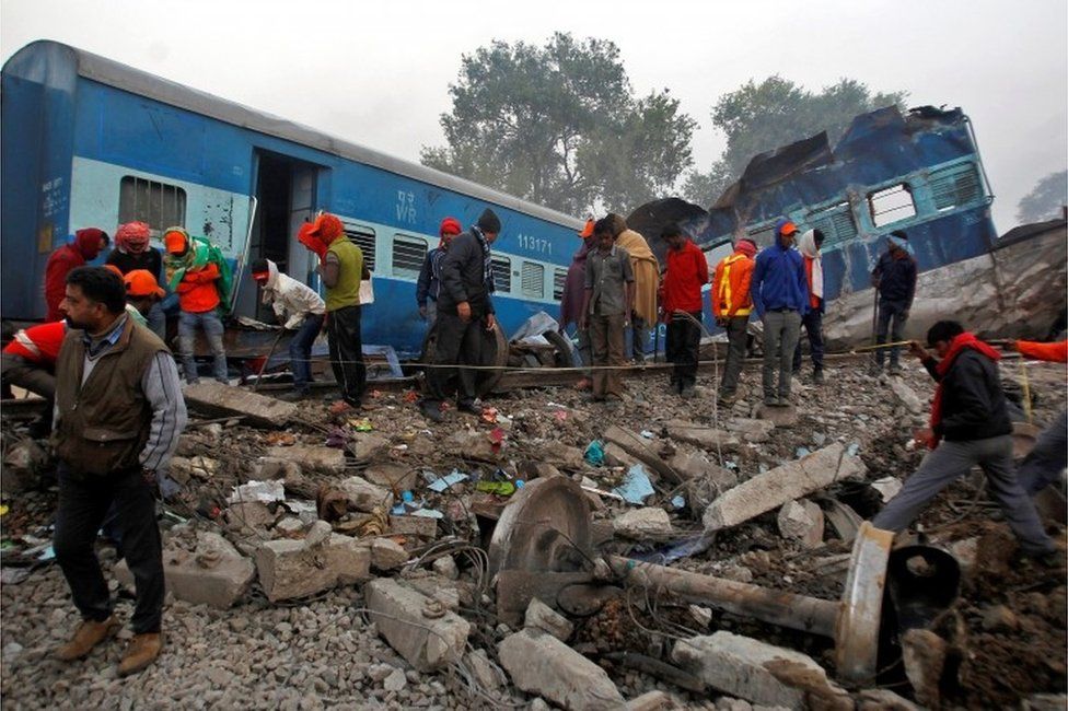 Спасатели ищут выживших на месте крушения поезда в воскресенье в Пухраяне, к югу от города Канпур, Индия, 21 ноября 2016 года.
