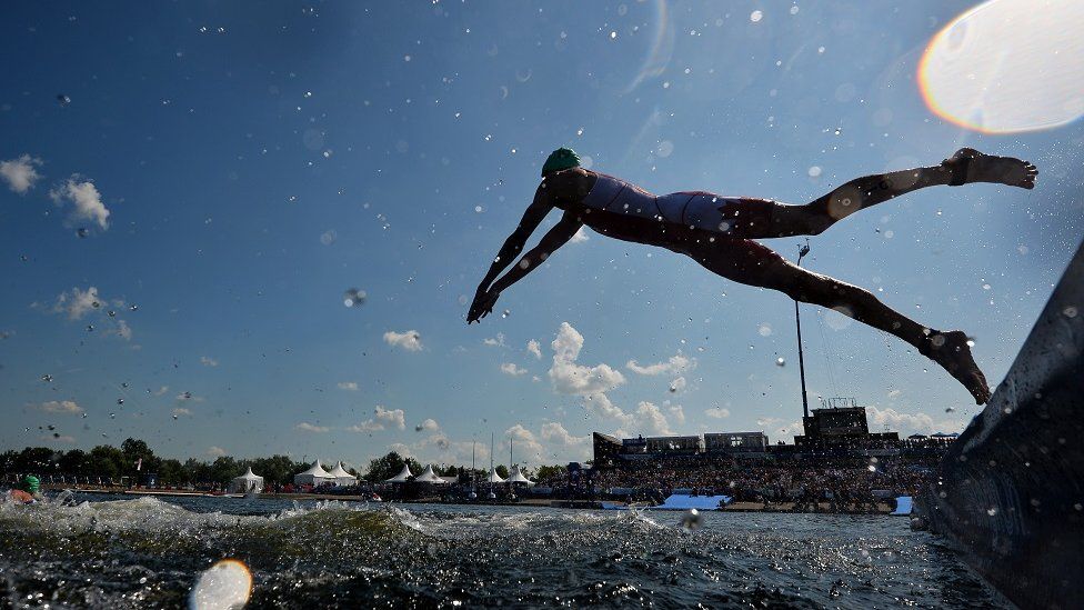 Athletes dive into the water in the men's Triathlon Final at Strathclyde Country Park near Glasgow during the 2014 Commonwealth Games in Glasgow