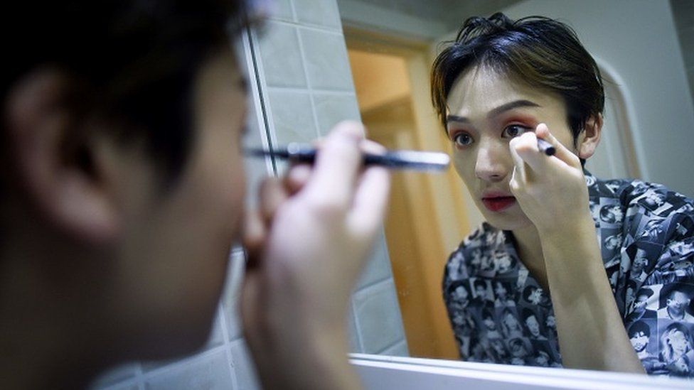 Lan Haoyi doing make up before recording video at his home in Beijing