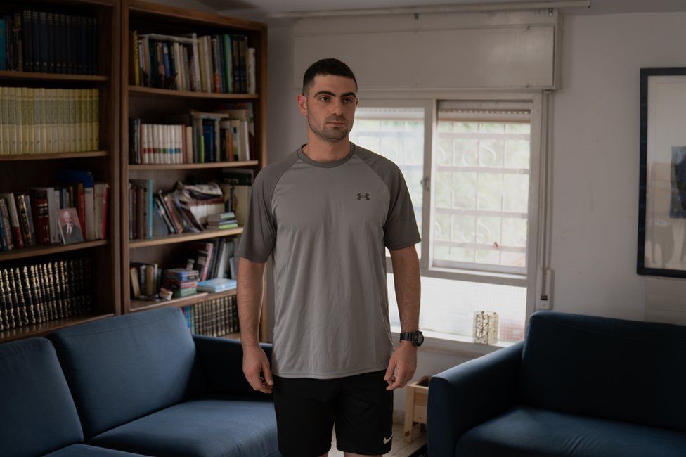 Army reservist Michael Goldberg at home in Jerusalem. "There is a lot of adrenaline," he said. (Joel Gunter)