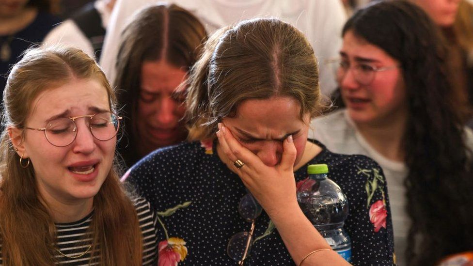 Mourners cry at the funeral of British-Israeli sisters Rina and Maya Dee