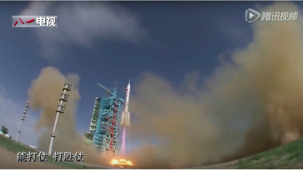 Large space rocket takes off from launch pad and blue-coloured gantry