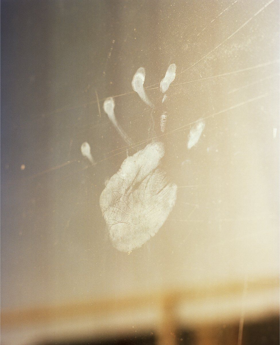 An image of a handprint on glass