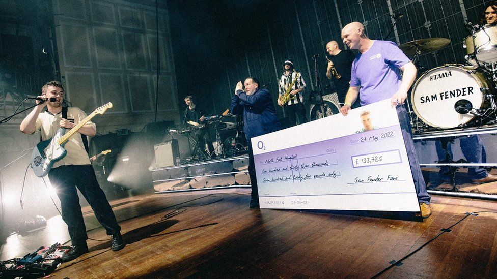 Sam Fender and the cheque for NEH North East Homeless