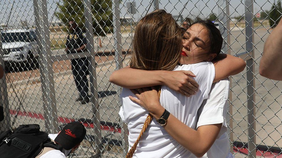 Alexandria Ocasio-Cortez is embraced at the Tornillo-Guadalupe port of entry gate on June 24, 2018 in Tornillo, Texas.