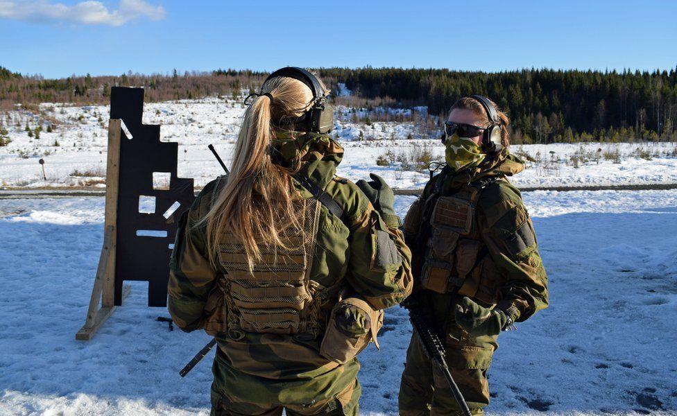 Two soldiers talk during training