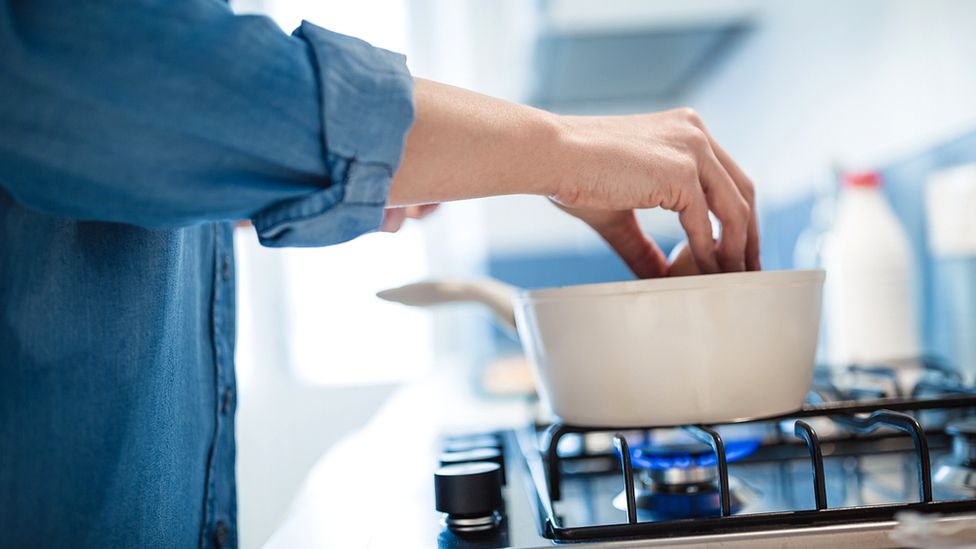 Woman cooking connected  state  stove