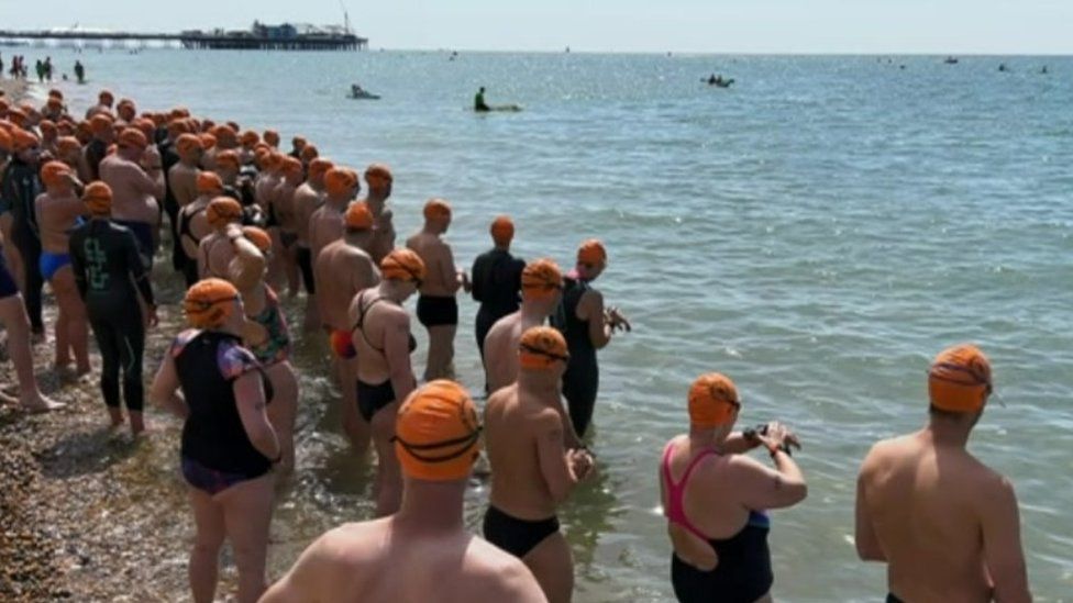 Swimmers about to set off from teh beach