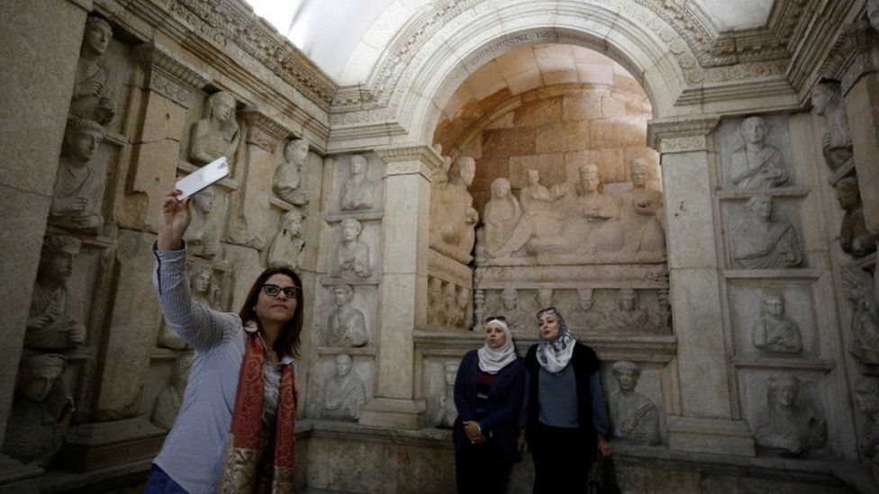 Three women take a selfie during its re-opening