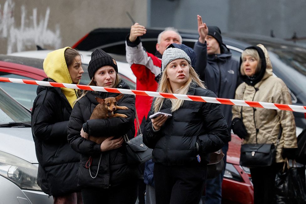 People react at the site of a Russian missile strike in Kyiv, after Russia launched a missile attack on Ukraine