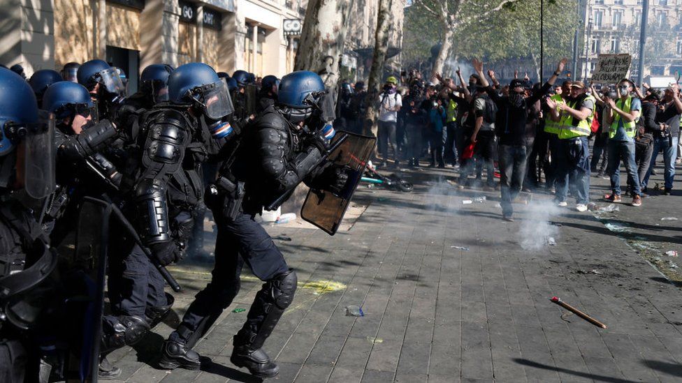 Riot policemen charge during clashes with Gilets Jaunes protesters in Paris, 2019