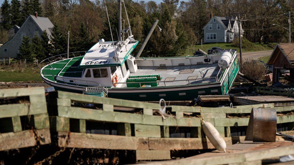 A view of damage at the Stanley Bridge Marina, including a boat knocked ashore from wind and storm surge, a day after Post-Tropical Storm Fiona hit the Atlantic coast