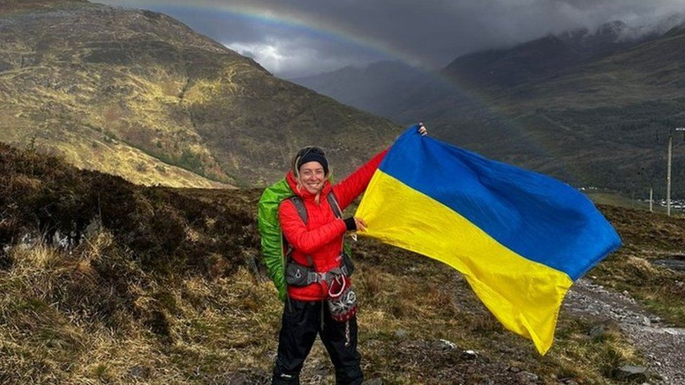 Sofiia Volovyk holding the Ukrainian flag on Ben Nevis