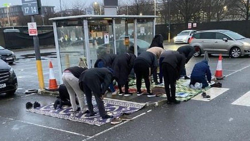 Drivers praying at bus stop