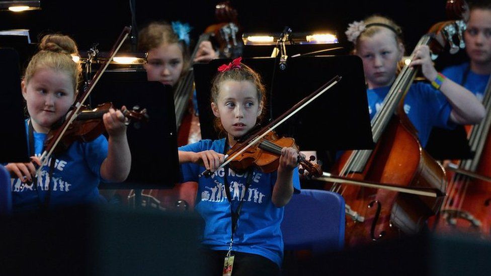 Children from the Raploch estate Big Noise orchestra play at The Big Concert on 21 June 2012 in Stirling, Scotland