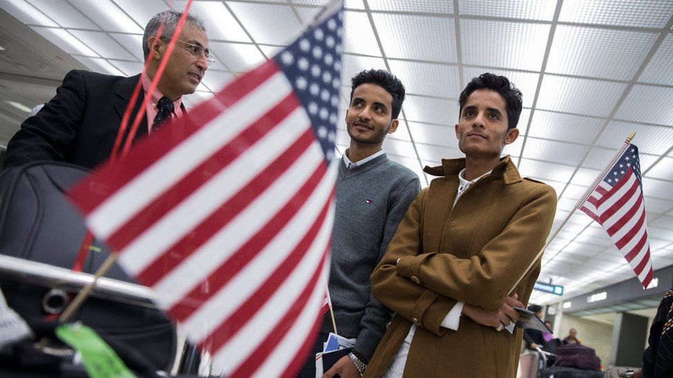 Tareq Aziz (L) and his brother Ammar Aziz (R), Yemeni nationals who were denied entry under the Trump administration travel ban, leave Dulles Airport, near Washingotn DC, with their father (6 February)
