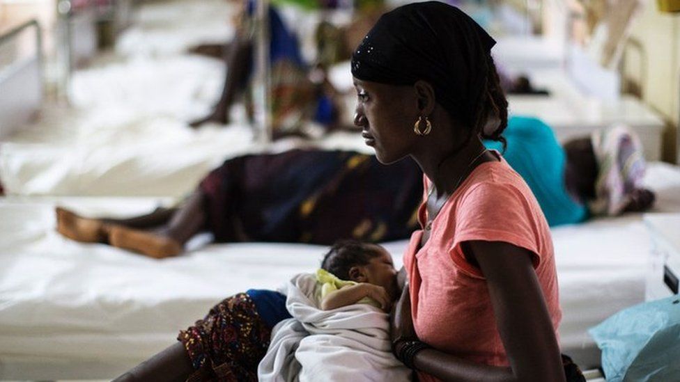 A mother nurses her newborn at the maternity ward of the Kailahun Government hospital on April 26, 2016, eastern Sierra Leone. UNFPA (United Nation Population Fund) supports the local Ministry of Health with a program that promotes maternal health and family planning