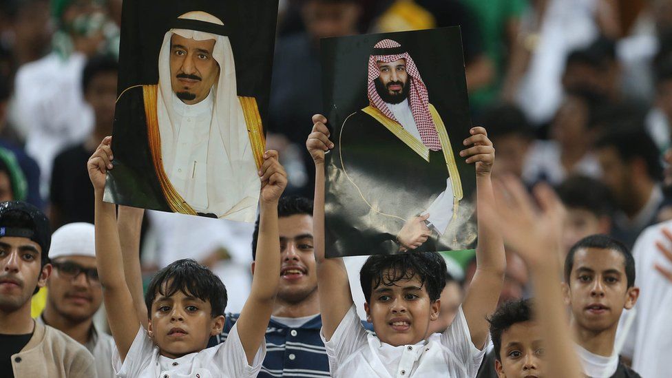 Saudi Arabia fans hold up portraits of King Salman and Crown Prince Mohammed bin Salman at a football match in Jeddah on 5 September 2017