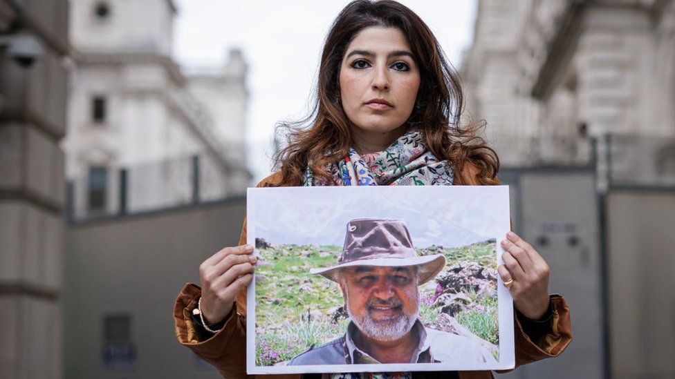 Roxanne Tahbaz holds a photograph of her father, Morad Tahbaz, outside the Foreign, Commonwealth and Development Office