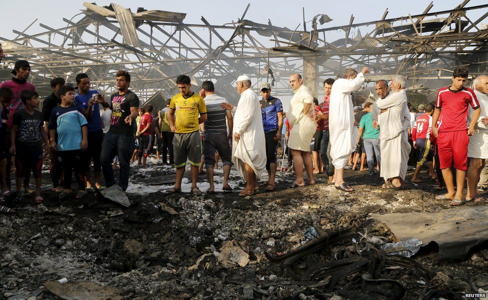 Residents gather at the site of a truck bomb attack at a crowded market in Baghdad ,August 13,2015.