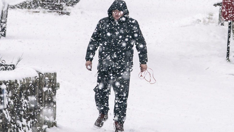 Man walks in snow