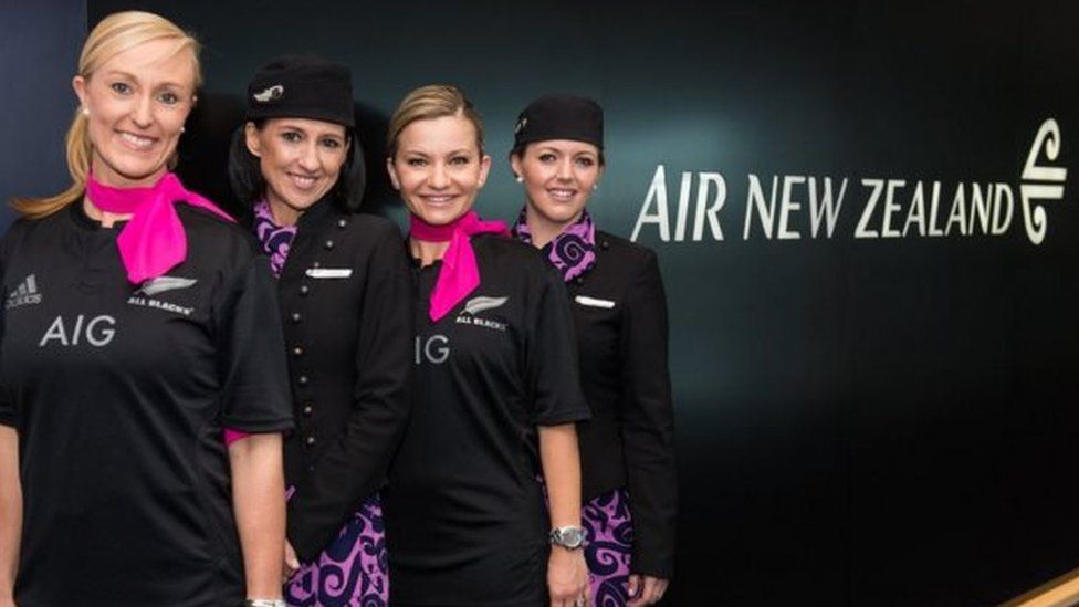 Good sports: Staff on board Australia's national carrier Qantas were all smiles when they donned the All Blacks jerseys on Monday following a social media wager